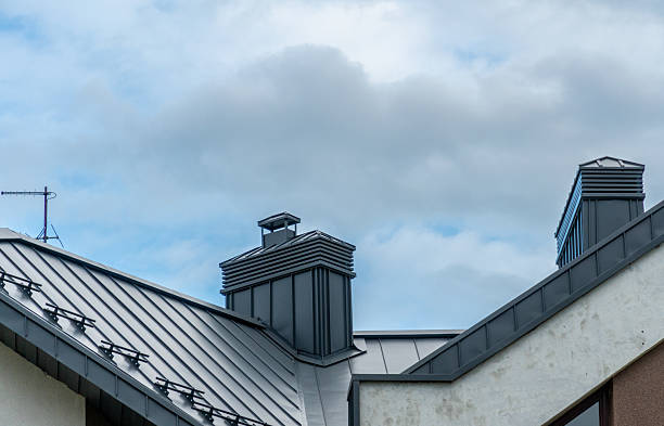 istock Architectural features include metal roofs and chimneys, creating a modern aesthetic under a dramatic sky filled with clouds. The scene captures an urban environment 2223287009