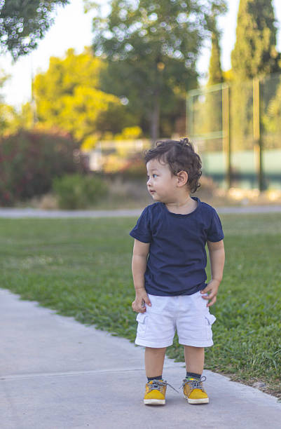 istock Curious toddler exploring a sunny park surrounded by greenery and vibrant colors 2223287182