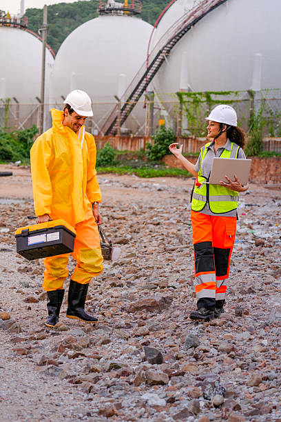 istock Two environmental researchers walk back from shoreline testing. They carry safety gear, a toolbox, a respirator mask, and a laptop after collecting water samples from a contaminated coast. 2223287211