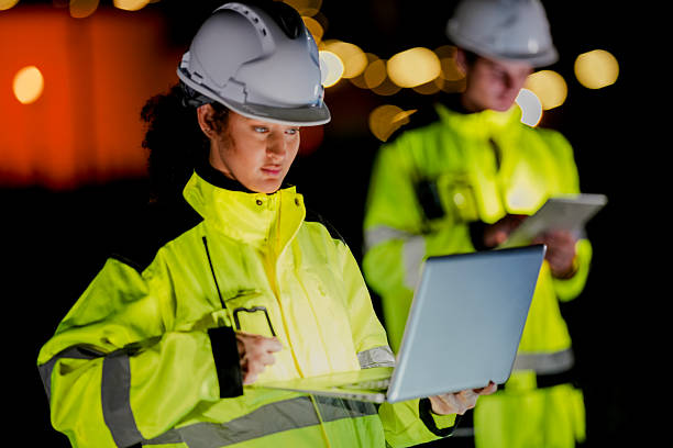 istock Two engineers collaborate on a night shift using a laptop and tablet at a plant A concept for the Fourth Industrial Revolution predictive maintenance and the Industrial Internet of Things 2223287482
