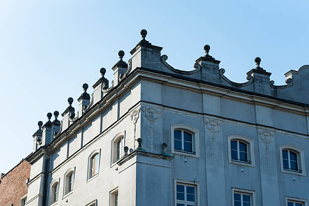 Classic historical building facade with decorative architecture in Krakow, Poland. For illustrating historic architecture, urban design, or cityscape themes.