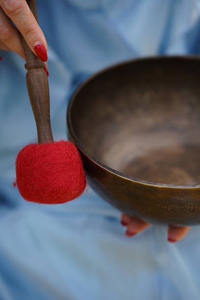istock Hand Holding Mallet Over Singing Bowl 2223295936