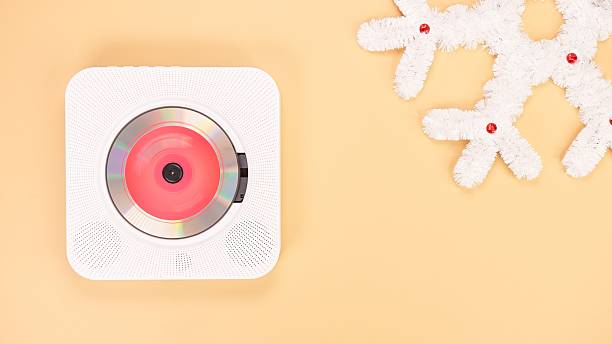 istock White portable CD player on a beige background with a decorative snowflake 2223298831