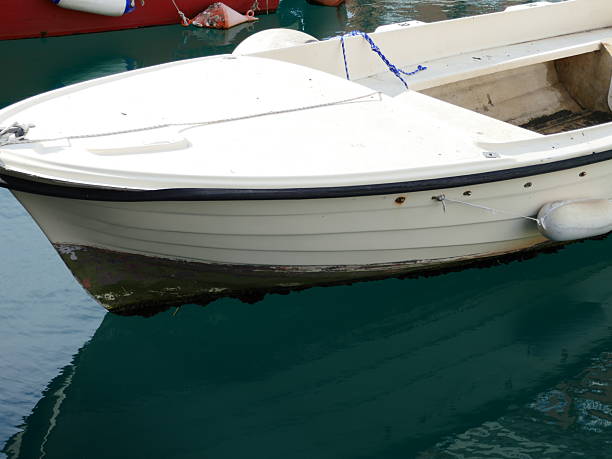 istock Reflection of boat in water with gentle ocean waves rippling on surface 2223303915