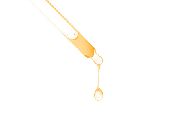istock gold serum oil dripping from dropper isolated on white background 2223306256