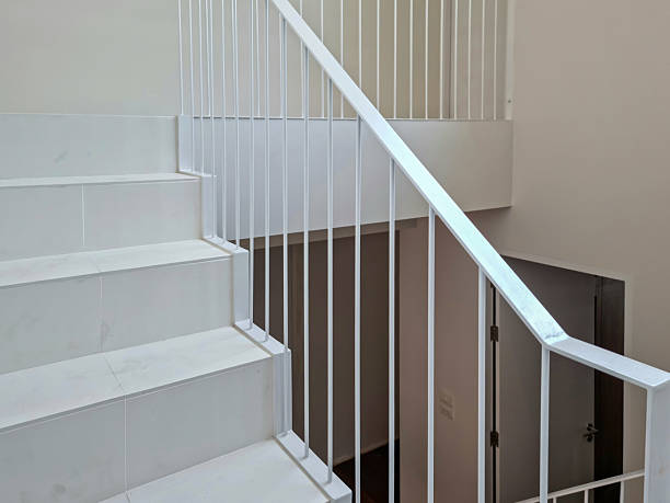 istock White wooden staircase frame on abstract background 2223306324