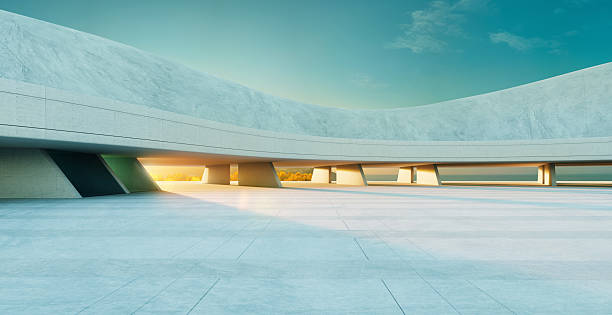istock 3D rendering modern concrete building exterior with empty parking lot at sunset 2223307288