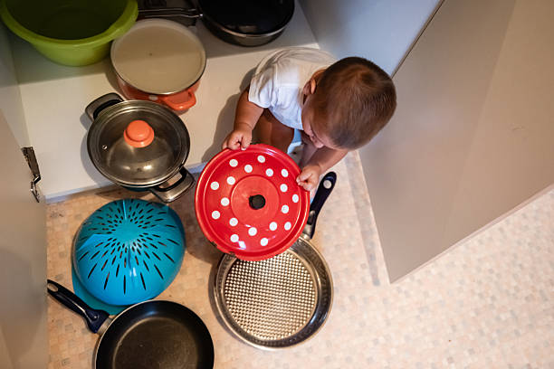 istock Baby playing with pots and pans in kitchen cabinet 2223308361