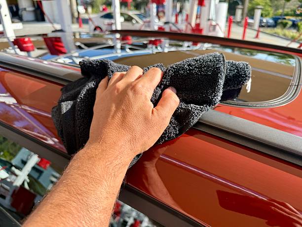 istock Man hand cleaning car with microfiber cloth at car wash 2223311757