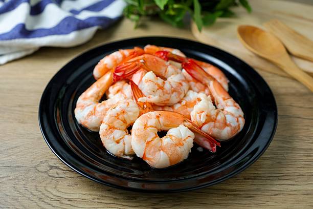 Bowl of shrimps over a wooden surface