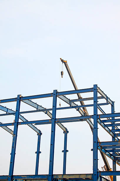 istock Workers installing steel frame in a factory, China 2223315583