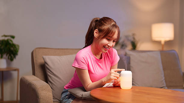 istock Aromatherapy Diffuser for Relaxation Asian Woman Enhancing Wellness with Essential Oils At Home Reduce Stress Indoor Living Promoting Calm Wellbeing Happy Adult 2223315900