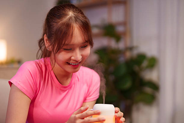 istock Asian Woman Using Aromatherapy Diffuser for Wellness and Longevity Lifestyle at Home Enhance Your Health with Aromatherapy for Relaxation and Better Sleep 2223315909