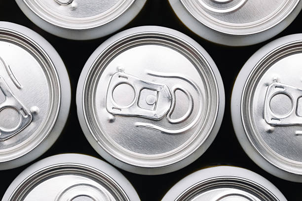 istock Top view of soda cans. Beverage containers arranged in pattern. Silver drink cans with pull tabs. Refreshing drink packaging. 2223316251