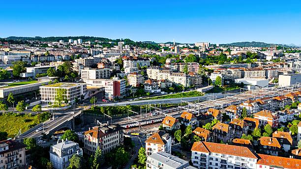 istock Aerial view of Lausanne railway station with dense train tracks and modern infrastructure, surrounded by urban buildings and Lake Geneva in the background, Transportation and travel hub in Vaud, Switzerland 2223316632