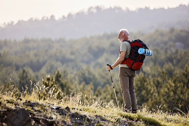 istock Carefree senior man hiking in spring day on a hill. 2223321652