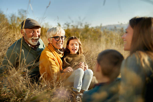 istock Happy extended family enjoying while talking in autumn day on a hill. 2223322251