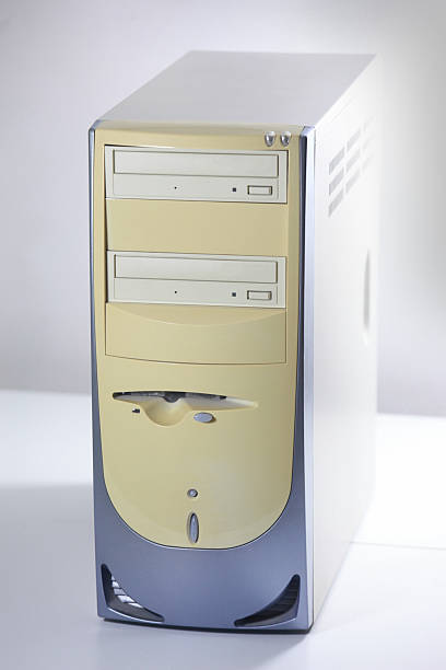 Retro computer tower: classic beige and grey PC casing with optical drives, isolated for vintage technology themes.