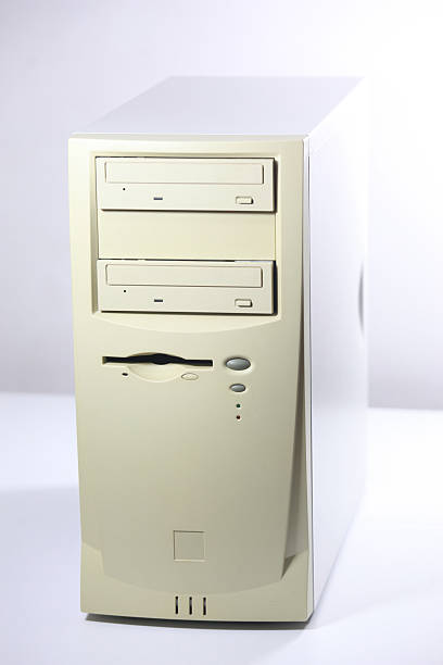 istock Vintage computer tower: a classic beige PC casing with disk drives, Isolated on white background. 2223326018