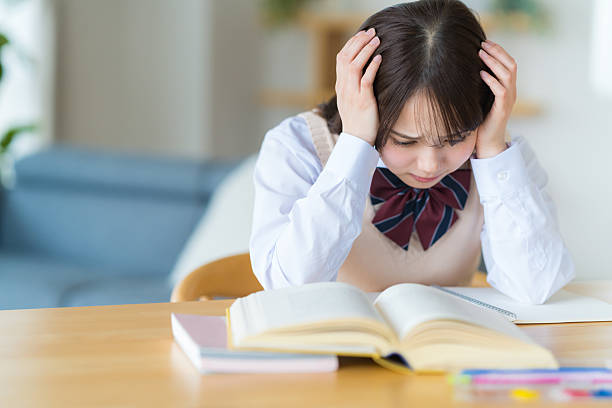 istock High school girl worried while studying at home 2223326568