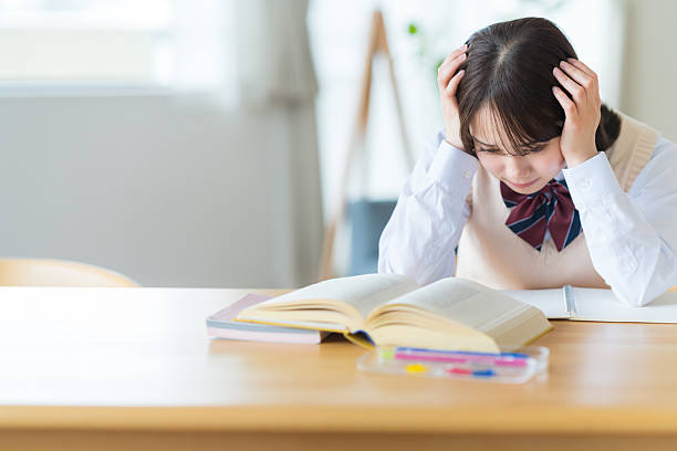 istock High school girl worried while studying at home 2223326580