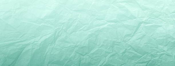 istock Crumpled mint turquoise pastel paper background with gradient, macro. Texture of wrinkled light cyan backdrop 2223329099