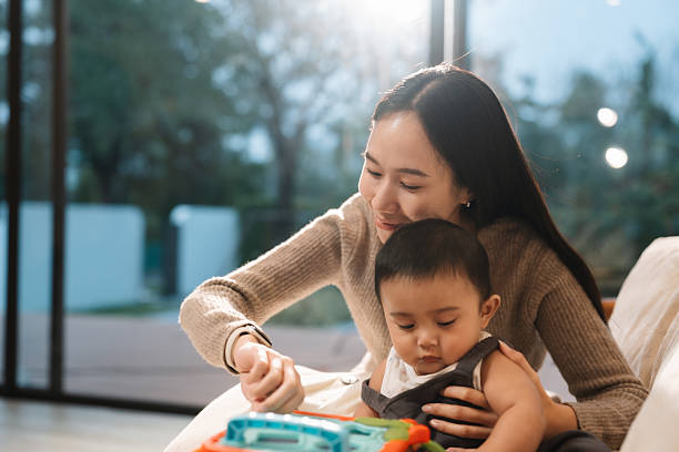 istock Curious baby happily playing colorful developmental toys 2223331527