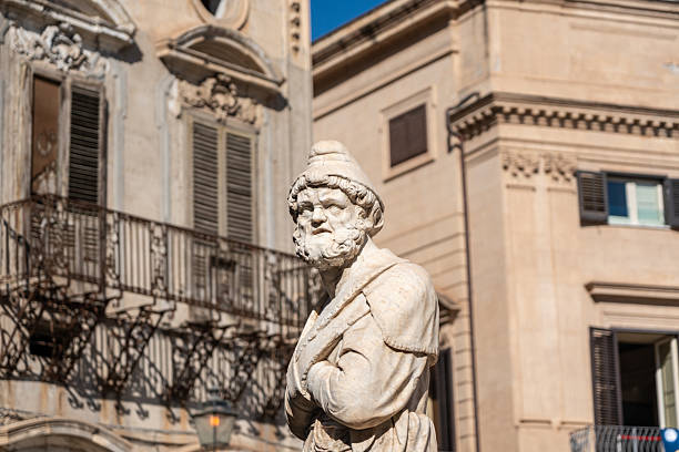 Palermo, Italy, November 18, 2024: Marble statue at Quattro Canti in Palermo stands amid baroque architecture and ornate balconies in the city historic core, editorial image
