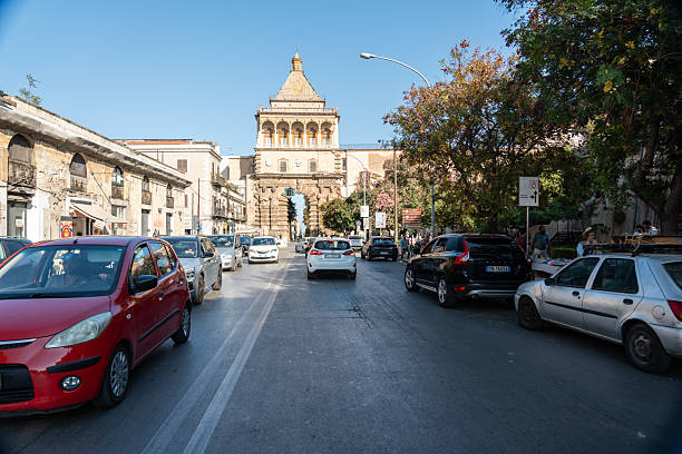 Palermo, Italy, November 18, 2024: Traffic flows along Corso Vittorio Emanuele toward Porta Nuova in Palermo, merging history with urban Mediterranean life, editorial image