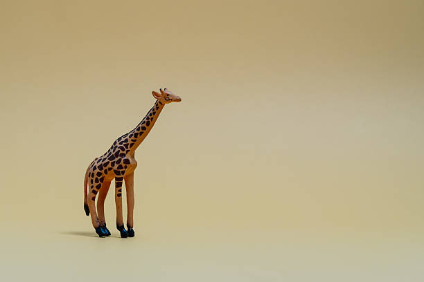 istock Toy giraffe on minimalist beige background 2223334187