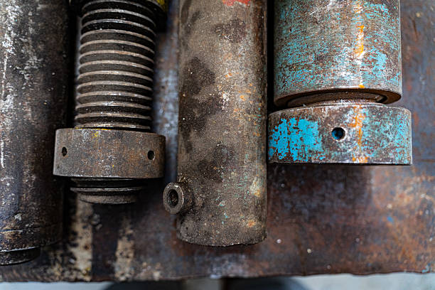 A detailed close-up of rusted and weathered metal components, showcasing textures and colors from years of use and exposure.