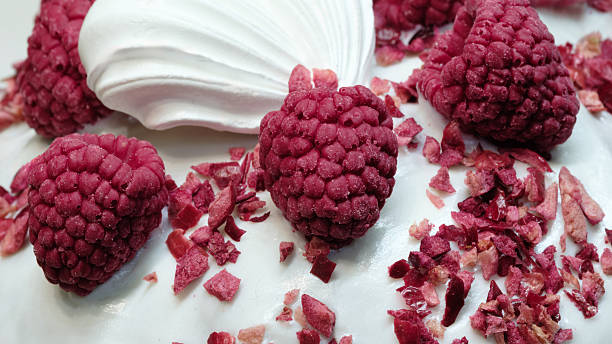 istock A dessert with a raspberry topping. The dessert is topped with a white frosting and has a raspberry garnish 2223336932