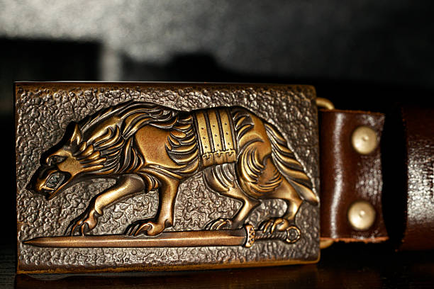 blacksmith forged art object for male belt with wolf shape folk symbol close up view