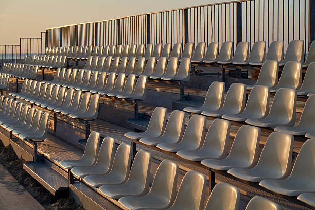 Rows of stadium seats in the evening light at the beach of Deauville, France.