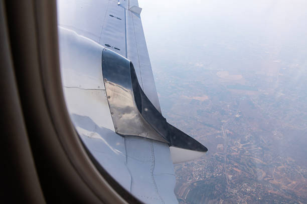 istock window and wing of the flying airplane 2223346109