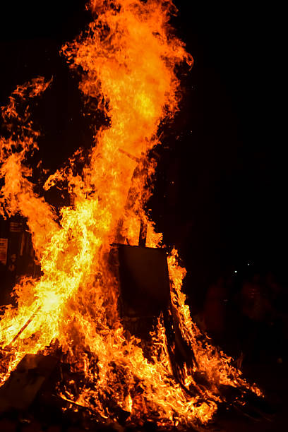 istock Fire flames on black background, Blaze fire flame texture background, Beautifully, the fire is burning, Fire flames with wood and cow dung bonfire 2223346645