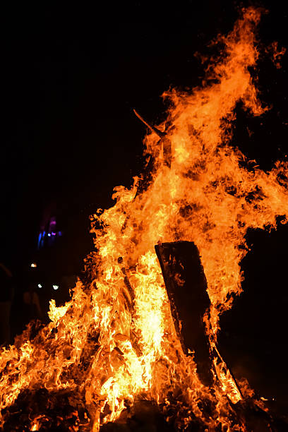 istock Fire flames on black background, Blaze fire flame texture background, Beautifully, the fire is burning, Fire flames with wood and cow dung bonfire 2223346657