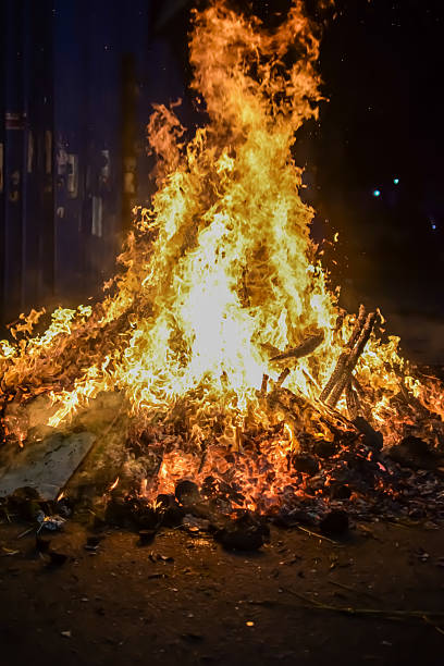 istock Fire flames on black background, Blaze fire flame texture background, Beautifully, the fire is burning, Fire flames with wood and cow dung bonfire 2223346676