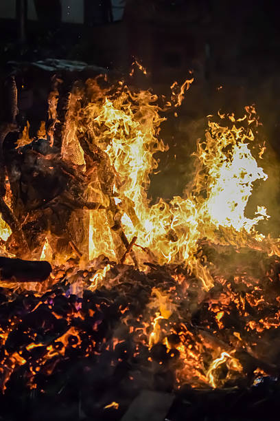 istock Fire flames on black background, Blaze fire flame texture background, Beautifully, the fire is burning, Fire flames with wood and cow dung bonfire 2223346709
