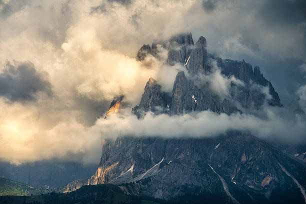 istock Majestic alpine mountains covered by clouds at dramatic sunset 2223347699