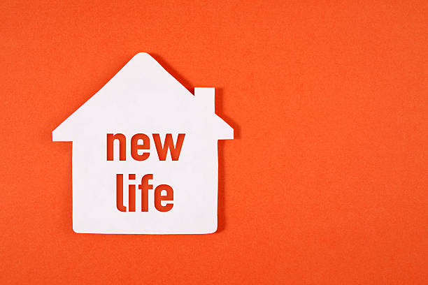 house shaped paper with new life word on orange background