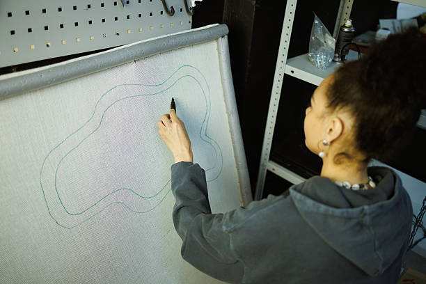 istock African american craftswoman marking canvas for carpet in workshop 2223350039