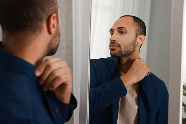 istock Worried man looking at mirror at home 2223351216