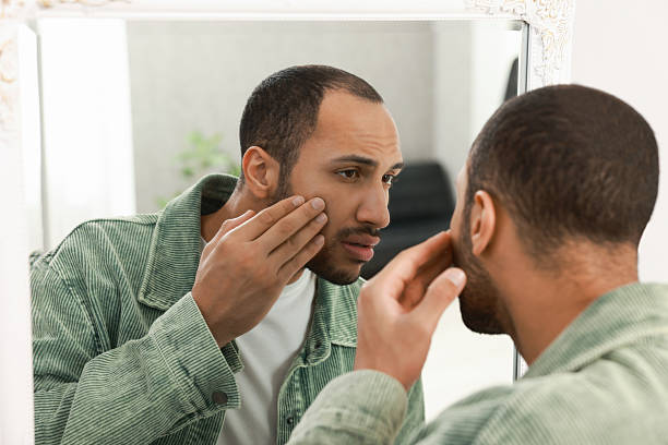 istock Worried man looking at mirror at home 2223351309