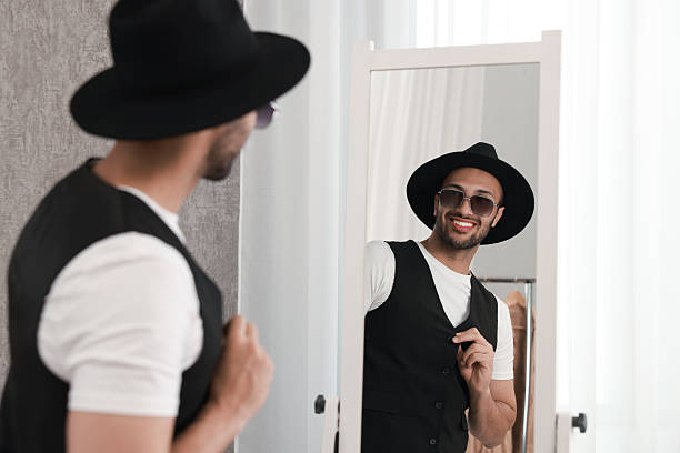 istock Smiling man looking at mirror at home 2223351323