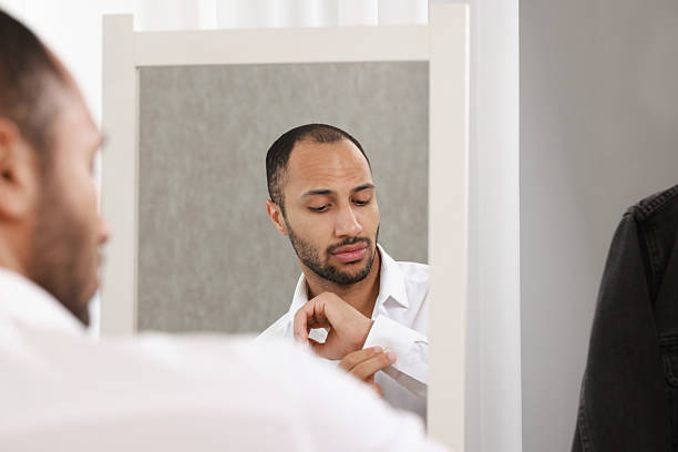 istock Handsome man dressing near mirror at home 2223351367