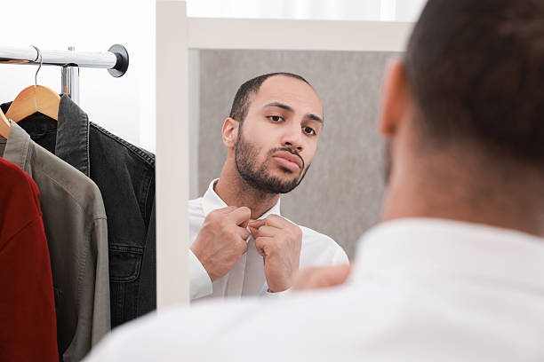 istock Handsome man dressing near mirror at home 2223351476
