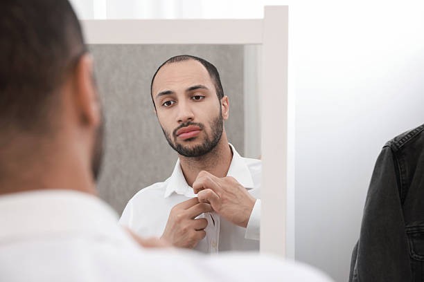 istock Handsome man dressing near mirror at home 2223351541