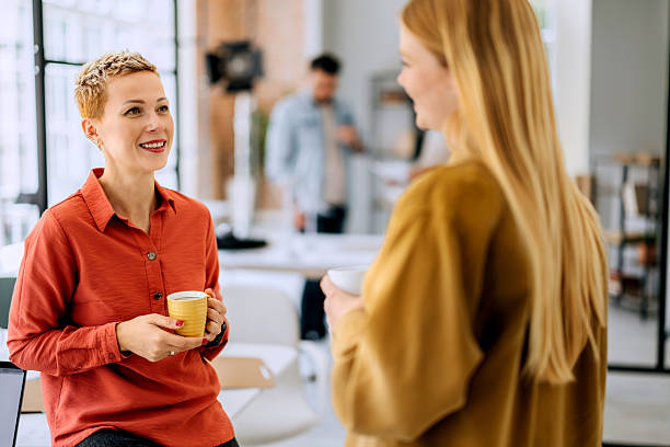 istock Two female colleagues casually talking during coffee break at the office 2223351996