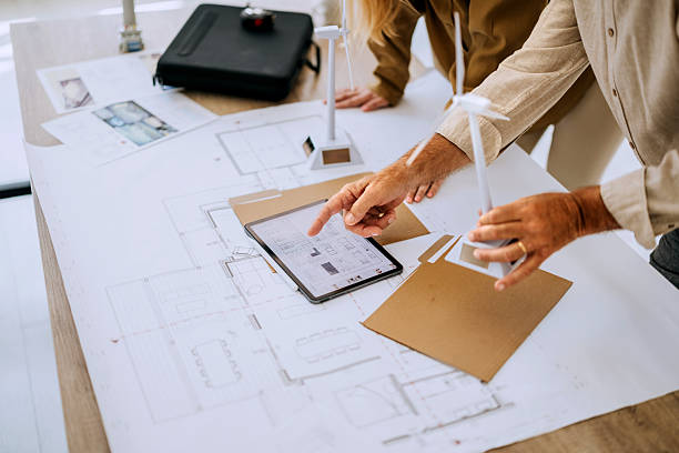istock Colleagues working together on wind energy model at office 2223352065